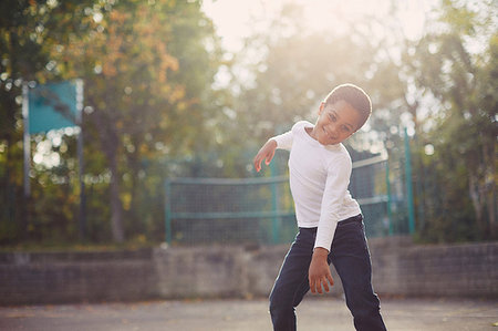 simsearch:614-05523145,k - Elementary schoolboy dancing in playground Stock Photo - Premium Royalty-Free, Code: 649-09209401