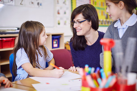 Girls drawing at desks in elementary school classroom Stock Photo - Premium Royalty-Free, Code: 649-09209413