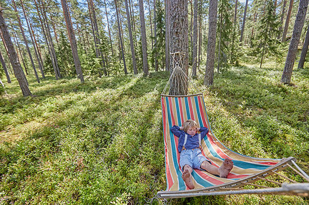 Boy dressed in retro clothing asleep on forest hammock Stock Photo - Premium Royalty-Free, Code: 649-09209703