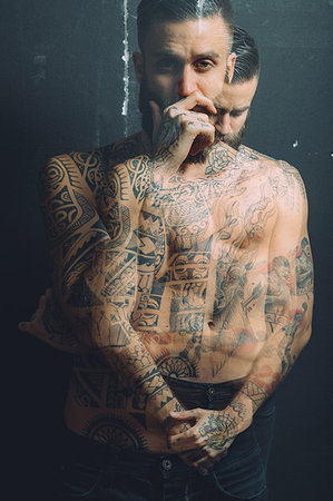 simsearch:649-09212515,k - Multiple exposure of bare chested young man, covered in tattoos, pensive, worried expressions Stock Photo - Premium Royalty-Free, Code: 649-09212532