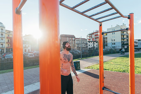 simsearch:649-08543172,k - Man contemplating horizontal ladder in outdoor gym Stock Photo - Premium Royalty-Free, Code: 649-09212794