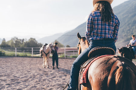 plaid shirt - Cowgirl riding horse in rural equestrian arena, Primaluna, Trentino-Alto Adige, Italy Stock Photo - Premium Royalty-Free, Code: 649-09212957
