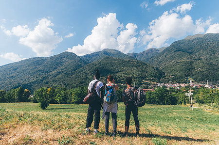 Three young hiking friends looking towards mountains, rear view, Primaluna, Trentino-Alto Adige, Italy Stock Photo - Premium Royalty-Free, Code: 649-09213027
