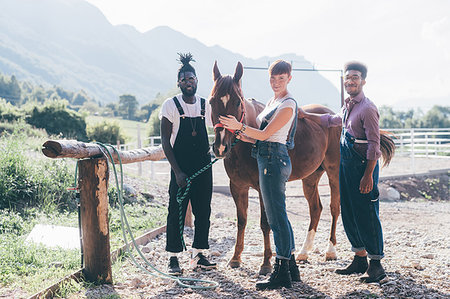 Young woman and men bonding with horse in rural equestrian arena, Primaluna, Trentino-Alto Adige, Italy Stock Photo - Premium Royalty-Free, Code: 649-09213045