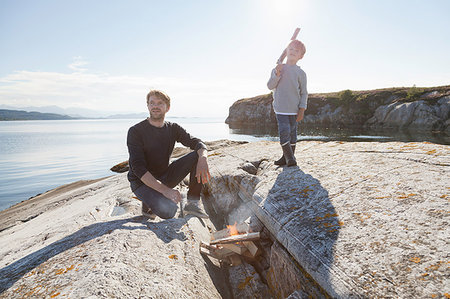 simsearch:614-09212422,k - Boy and father by campfire on inlet rock, Aure, More og Romsdal, Norway Stock Photo - Premium Royalty-Free, Code: 649-09213644