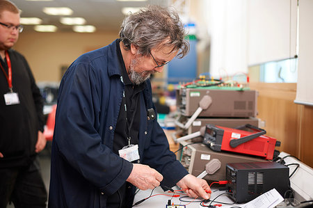 Lecturer preparing electrical instrument, student in background Stock Photo - Premium Royalty-Free, Code: 649-09230295