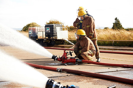 firefighters spray water - Firemen training to use fire hose, Darlington, UK Photographie de stock - Premium Libres de Droits, Code: 649-09230470