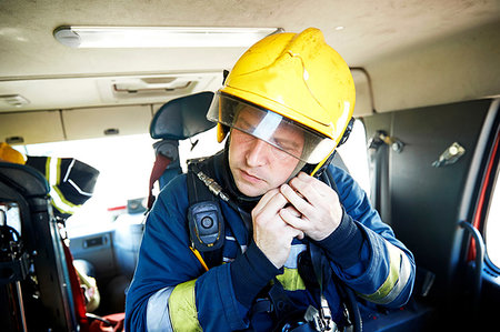 fire truck close - Fireman putting on helmet in fire engine Stock Photo - Premium Royalty-Free, Code: 649-09230471