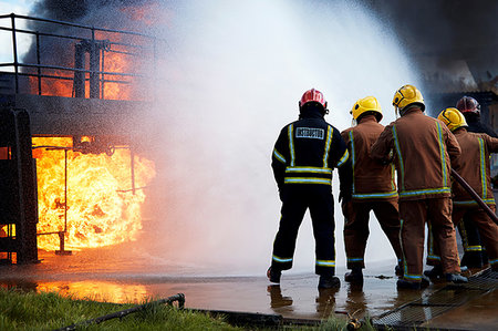 firefighters spray water - Firemen training to put out fire on burning building, Darlington, UK Photographie de stock - Premium Libres de Droits, Code: 649-09230495