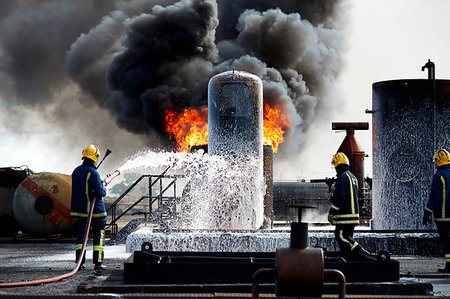 firefighters spray water - Firemen training to put out fire on burning tanks, Darlington, UK Stock Photo - Premium Royalty-Free, Code: 649-09230490