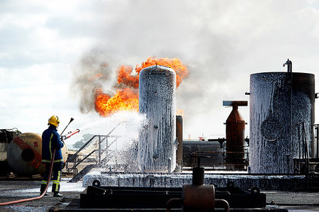 extinguishing (fire) - Fireman training to put out fire on burning tanks, Darlington, UK Stock Photo - Premium Royalty-Free, Code: 649-09230491