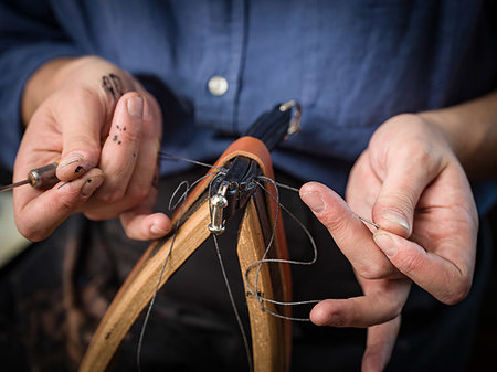 Leatherworker stitching handbag in workshop, close up of hands Stock Photo - Premium Royalty-Free, Code: 649-09230586