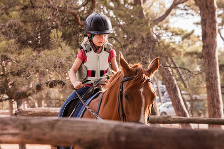 simsearch:649-09003830,k - Girl learning to ride horse in paddock Stock Photo - Premium Royalty-Free, Code: 649-09245856
