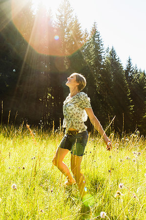 simsearch:614-08065892,k - Woman dancing amongst wild flowers in forest, Sonthofen, Bayern, Germany Stock Photo - Premium Royalty-Free, Code: 649-09246354