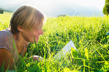 simsearch:649-09208838,k - Woman reading book on grass in countryside, Sonthofen, Bayern, Germany Stock Photo - Premium Royalty-Free, Code: 649-09246365