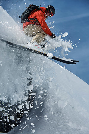 simsearch:649-09258452,k - Male skier skiing mid air down steep snow covered mountain, Alpe-d'Huez, Rhone-Alpes, France Stock Photo - Premium Royalty-Free, Code: 649-09246611