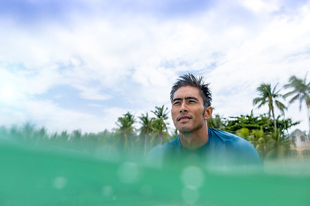 Surfer waiting in sea, Pagudpud, Ilocos Norte, Philippines Stock Photo - Premium Royalty-Free, Code: 649-09246759