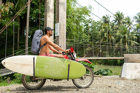 single coconut tree picture - Motorcyclist carrying surfboard on bike, Pagudpud, Ilocos Norte, Philippines Stock Photo - Premium Royalty-Free, Code: 649-09246766