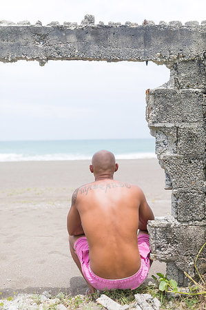 Man on abandoned site by sea, Pagudpud, Ilocos Norte, Philippines Stock Photo - Premium Royalty-Free, Code: 649-09246815