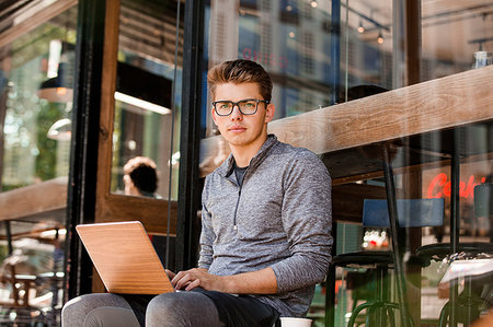 simsearch:649-09258330,k - Young man using laptop at cafe, London, UK Stock Photo - Premium Royalty-Free, Code: 649-09246852