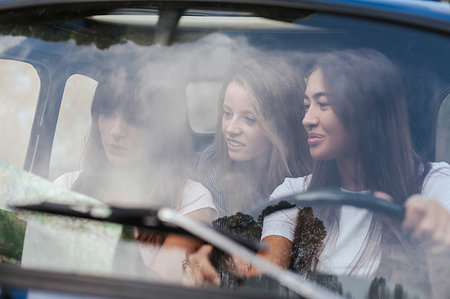 friends inside the car - Friends reading route map inside car Stock Photo - Premium Royalty-Free, Code: 649-09257185