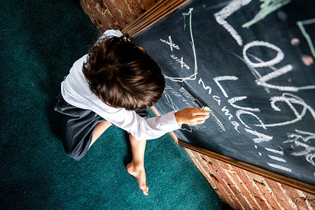 simsearch:614-06442827,k - Boy in school uniform writing on blackboard at home Stock Photo - Premium Royalty-Free, Code: 649-09257287