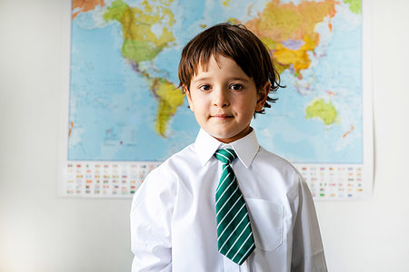 Portrait of boy in school uniform, World map in background Stock Photo - Premium Royalty-Free, Code: 649-09257281