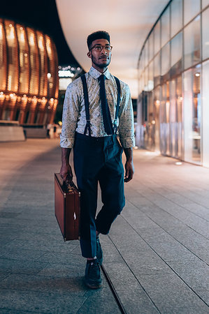 Businessman walking past buildings in city, Milano, Lombardia, Italy Stock Photo - Premium Royalty-Free, Code: 649-09257343