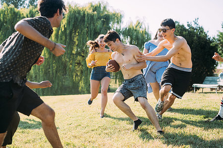 simsearch:649-07064326,k - Group of friends playing football in park Stock Photo - Premium Royalty-Free, Code: 649-09257829