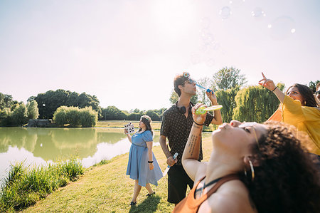 simsearch:649-08307271,k - Group of friends blowing bubbles in park Stock Photo - Premium Royalty-Free, Code: 649-09257822