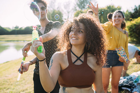 simsearch:649-08923568,k - Group of friends playing with bubble gun in park Stock Photo - Premium Royalty-Free, Code: 649-09257844