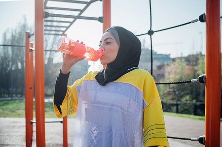 simsearch:649-09111293,k - Calisthenics class at outdoor gym, young woman drinking from water bottle Fotografie stock - Premium Royalty-Free, Codice: 649-09257969