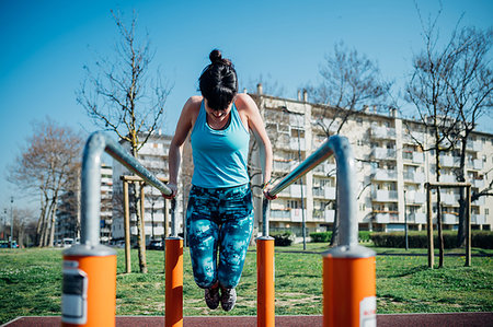 simsearch:649-08577265,k - Calisthenics class at outdoor gym, young woman doing push ups on parallel bars Stock Photo - Premium Royalty-Free, Code: 649-09257994