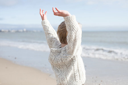 simsearch:649-07804544,k - Boy stretching arms on beach Stock Photo - Premium Royalty-Free, Code: 649-09258017