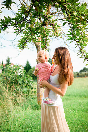 simsearch:649-09250257,k - Mother carrying toddler daughter under fruit tree, Arezzo, Tuscany, Italy Stock Photo - Premium Royalty-Free, Code: 649-09258023