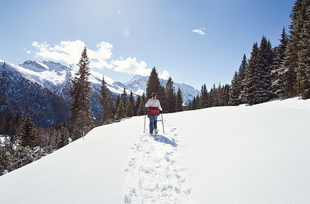 snowshoer (female) - Teenage girl snowshoeing in snow covered mountain landscape, rear view, Styria, Tyrol, Austria Stock Photo - Premium Royalty-Free, Code: 649-09258154