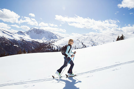 racchetta da sci - Mature woman snowshoeing up snow covered mountainside, Styria, Tyrol, Austria Fotografie stock - Premium Royalty-Free, Codice: 649-09258166