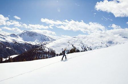 simsearch:649-09213580,k - Mature woman snowshoeing up snow covered mountainside, distant view, Styria, Tyrol, Austria Photographie de stock - Premium Libres de Droits, Code: 649-09258167