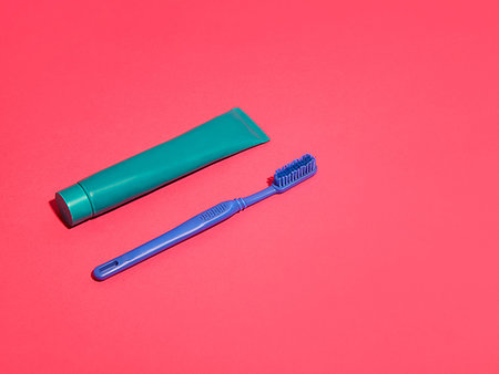 simsearch:640-02953202,k - Toothbrush and toothpaste on red background Stock Photo - Premium Royalty-Free, Code: 649-09258355