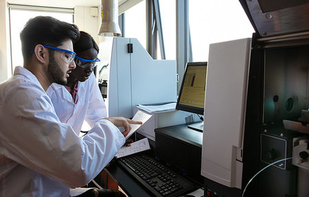 scientist pointing image - Young female and male scientists reading paperwork in laboratory Stock Photo - Premium Royalty-Free, Code: 649-09258367