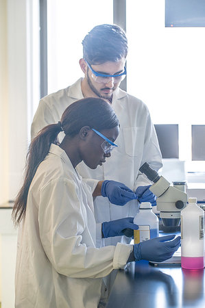 Young female and male scientists preparing chemicals for  laboratory experiment Stock Photo - Premium Royalty-Free, Code: 649-09258400