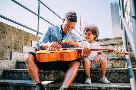 simsearch:614-02640837,k - Father teaching son play guitar on stairway Stock Photo - Premium Royalty-Free, Code: 649-09250135