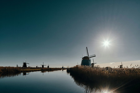 simsearch:649-07647992,k - Windmills along canal at dusk, Kinderdijk, Zuid-Holland, Netherlands Stock Photo - Premium Royalty-Free, Code: 649-09250203