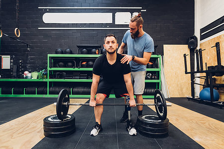 Man with prosthetic leg weight training in gym Stock Photo - Premium Royalty-Free, Code: 649-09250696