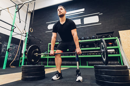 Man with prosthetic leg weight training in gym Stock Photo - Premium Royalty-Free, Code: 649-09250697