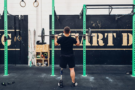 Man with prosthetic leg weight training in gym Stock Photo - Premium Royalty-Free, Code: 649-09250692