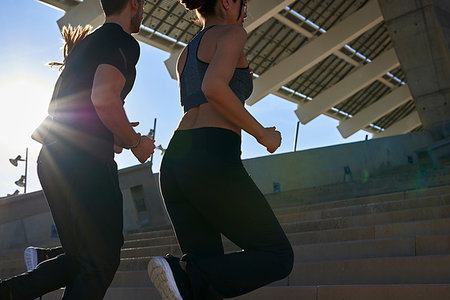 simsearch:649-07710113,k - Friends jogging up steps in sports stadium Foto de stock - Sin royalties Premium, Código: 649-09250773