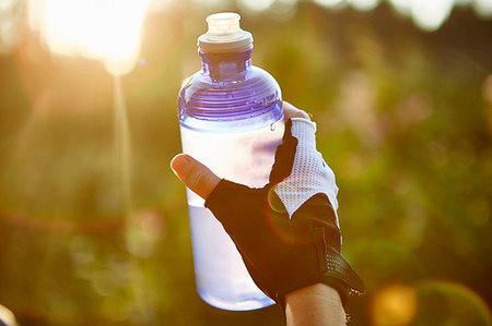 Female cyclist holding water bottle, close up of hand Stock Photo - Premium Royalty-Free, Code: 649-09251308