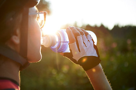simsearch:649-09111421,k - Female cyclist drinking from water bottle, cropped over shoulder view Stock Photo - Premium Royalty-Free, Code: 649-09251309