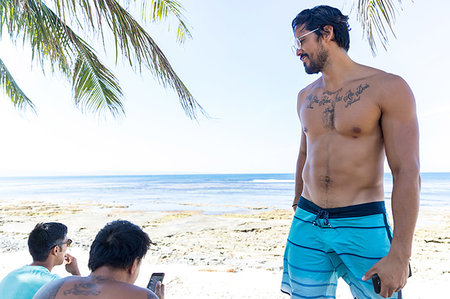 person smartphone tattoo - Friends talking and using smartphone on beach, Pagudpud, Ilocos Norte, Philippines Stock Photo - Premium Royalty-Free, Code: 649-09251348